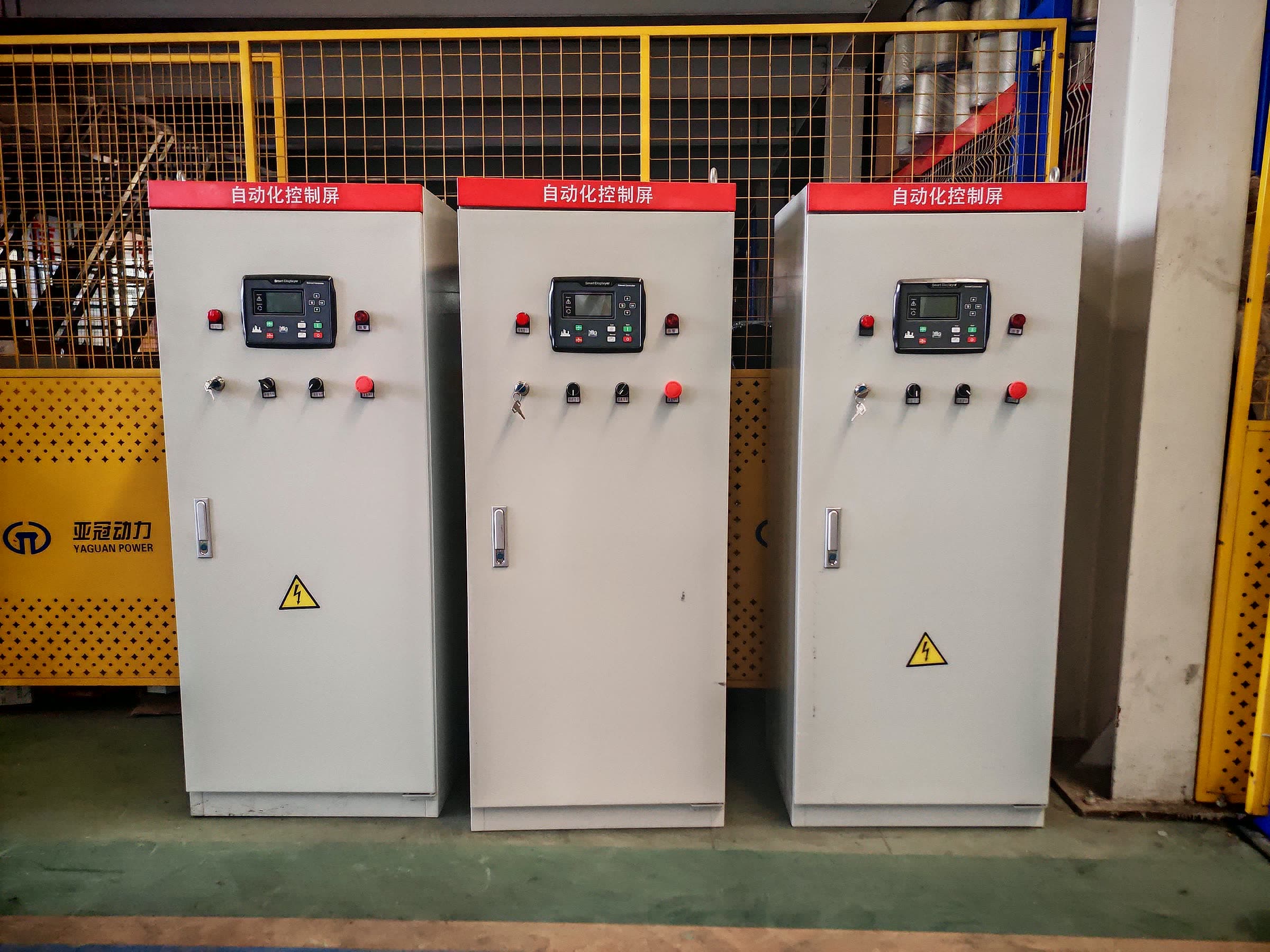 Automatic transfer switch cabinets on the assembly floor, panel doors and mimic busbars still exposed