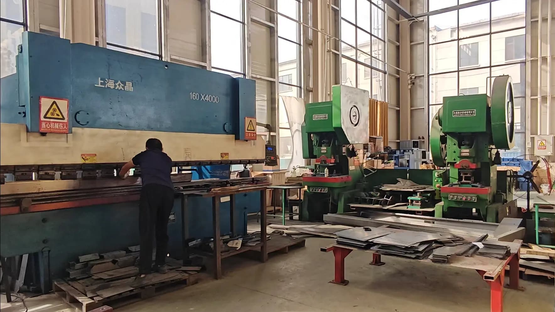 An operator bending steel plate on a 160 x 4000 press brake in the sheet metal workshop